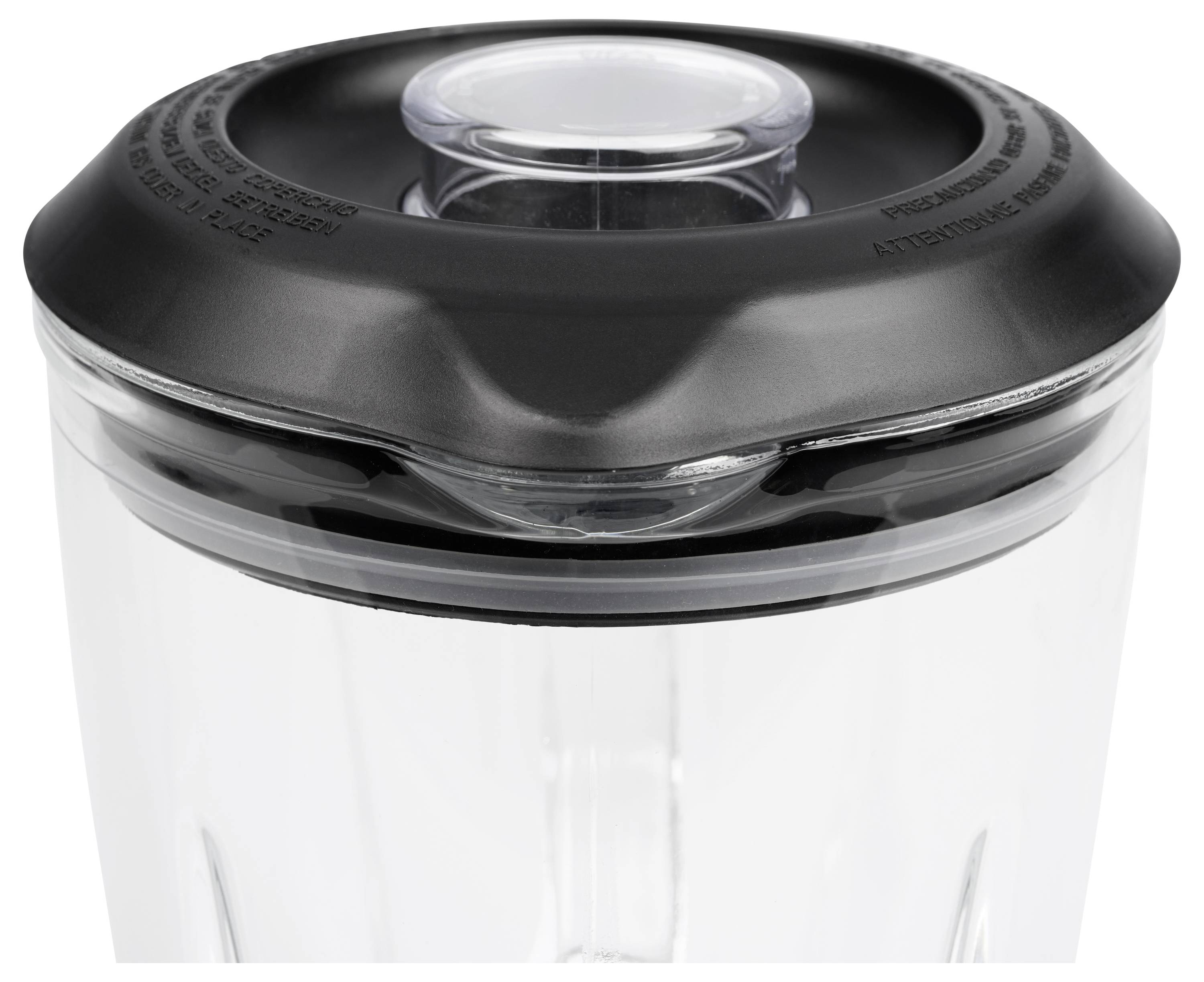 Close-up of a blender jar lid with a clear removable center cap and black rubber seal on a transparent container.