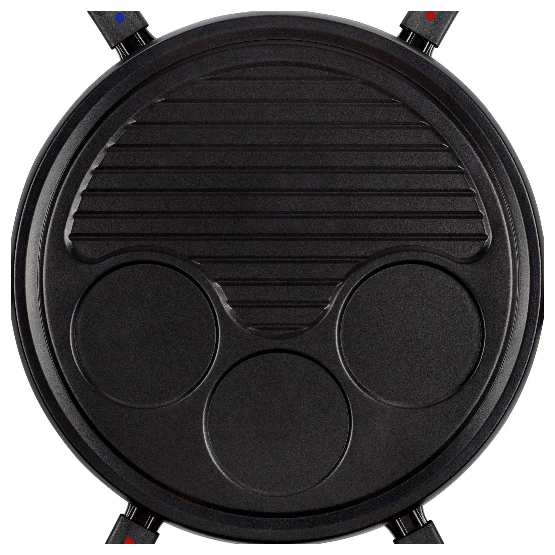 Round black electric grill or raclette pan with one ridged half and three circular sections, shown from above.<br>