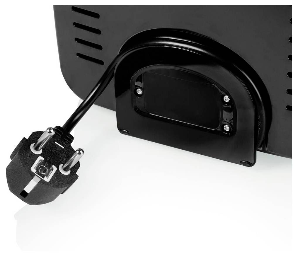 Close-up of the back of a black electronic device with a power cord and plug attached to a recessed port.<br>