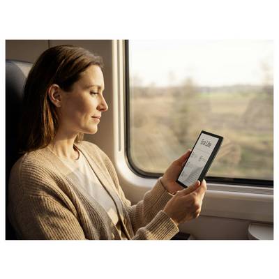 Woman on a train looking at a smartphone with a 'To-do list' screen, seated by a window in warm daylight.