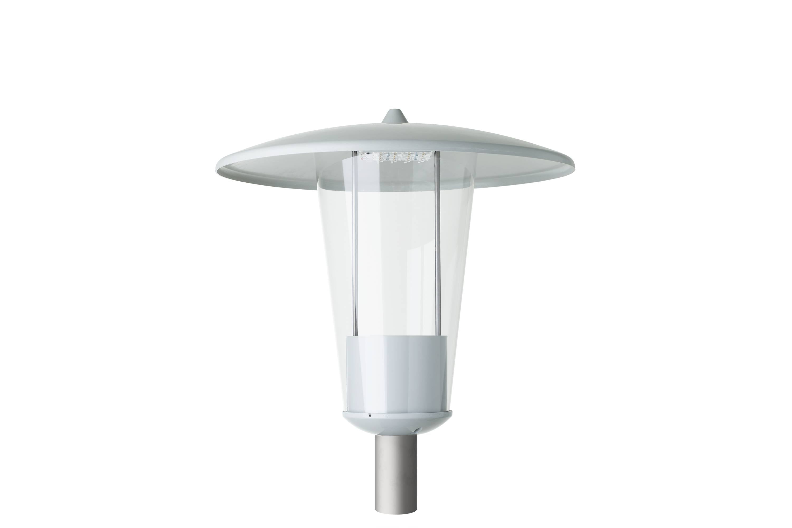 A modern outdoor lamp post with a wide flat canopy and clear cylindrical glass housing on a metal pole.