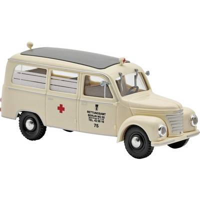 Beige vintage ambulance model van with red crosses and 'RETTUNGSAMT BERLIN' markings on the side.
