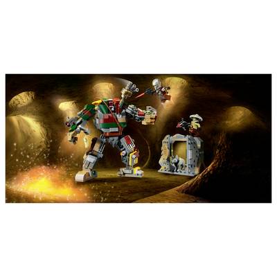 Two LEGO robots battle in a cave while a smaller figure guards a cage with a creature, with sparks and an explosion lighting the scene.