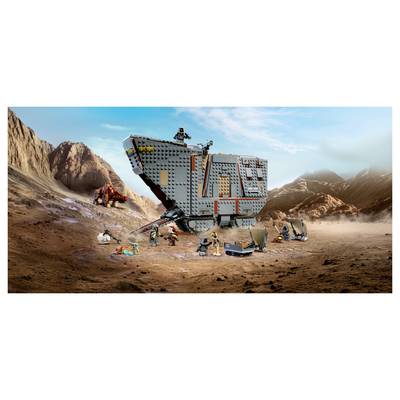 LEGO Star Wars battle scene with a large gray armored vehicle in a rocky desert, surrounded by minifigures and small combat vehicles amid dust and explosions.