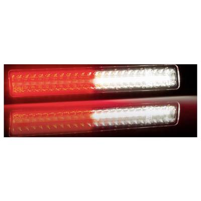 Close-up of two horizontal emergency vehicle light bars flashing red and white against a dark background.
