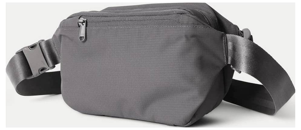 Gray waist bag with adjustable black strap and front zippered pocket on a light background.