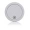 Round white smoke detector with a small speaker vent at the bottom, shown on a plain background.