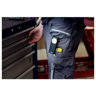 Close-up of a worker in dark cargo pants using a tool chest drawer, with a flashlight clipped to the pocket.