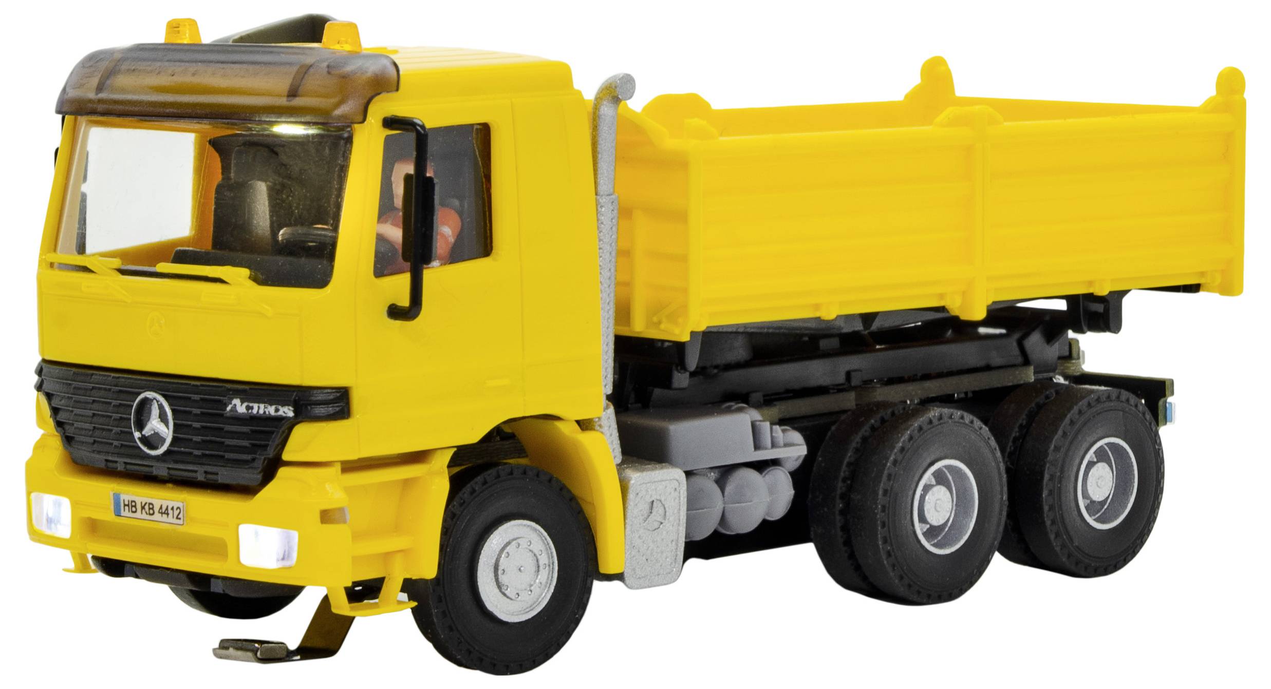 Yellow Mercedes-Benz Actros dump truck toy shown in side view on a white background.