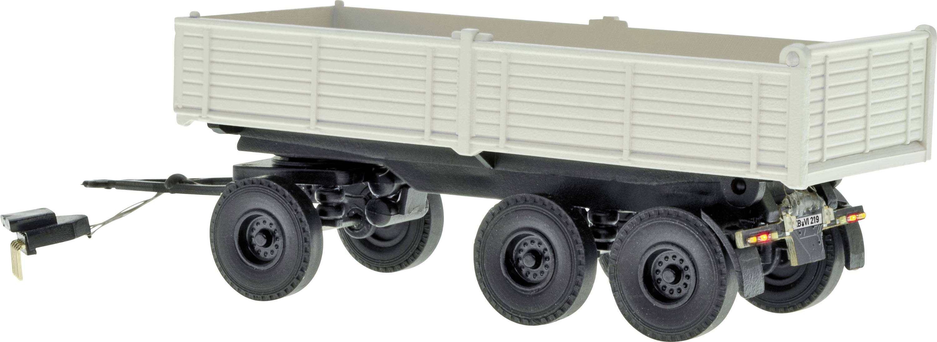 Large white multi-axle cargo trailer with a long ribbed bed and rear lights, shown isolated on a white background.
