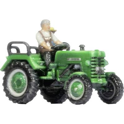 A small green toy tractor with a seated driver figure on a white background.