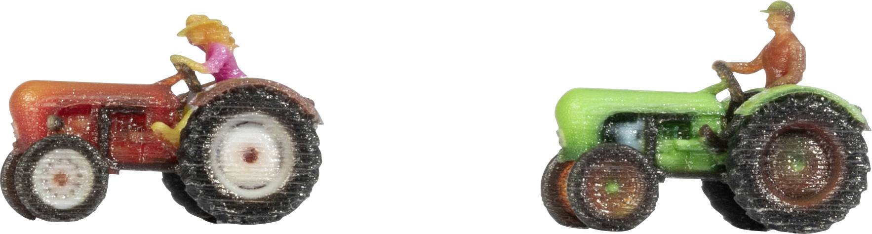 Two toy tractors side by side on a white background, one red with a pink driver and one green with an orange driver.