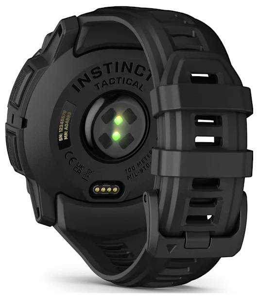 Rear view of a black Garmin Instinct Tactical smartwatch showing the heart-rate sensor, charging contacts, and rugged silicone strap.<br>