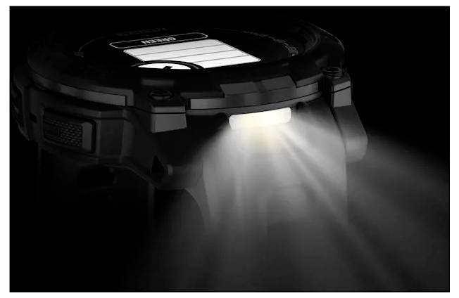 Close-up of a black headlamp emitting a bright white beam in the dark, highlighting the built-in light feature.