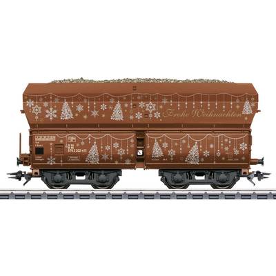 Side view of a brown freight hopper railcar decorated with white Christmas trees and snowflakes, with 'Frohe Weihnachten' written on the side.