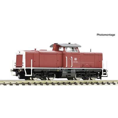 Side view of a red diesel locomotive on railroad tracks, shown in a photomontage on a white background.