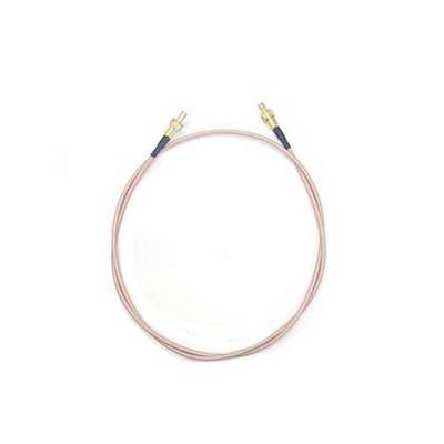 Coiled copper audio cable with gold connectors on a white background.