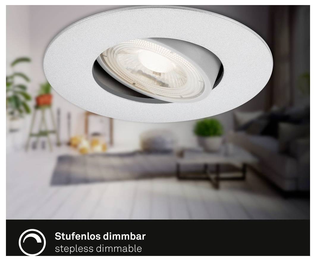 Close-up of a white recessed ceiling spotlight in a blurred living room, labeled 'Stufenlos dimmbar' and 'stepless dimmable'.<br>