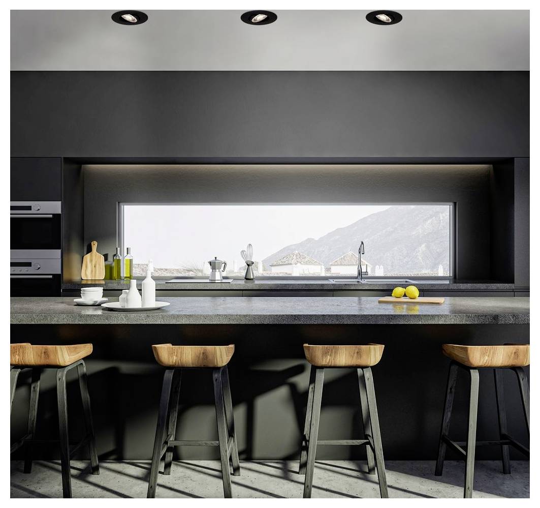 Modern black kitchen with four wooden bar stools and a wide window above the sink framing mountains outside.