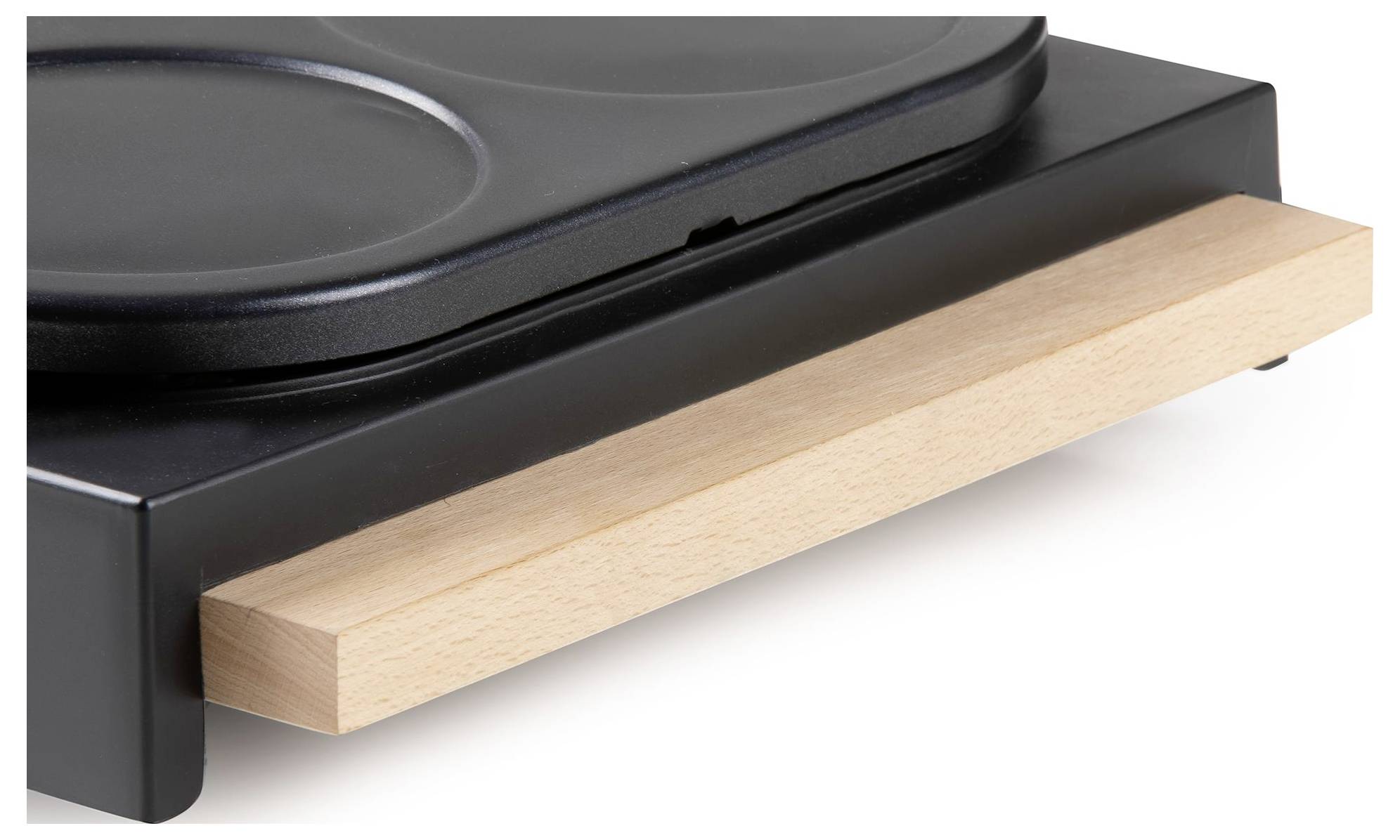 Close-up of a black appliance with a light wood handle or drawer pull on the front.