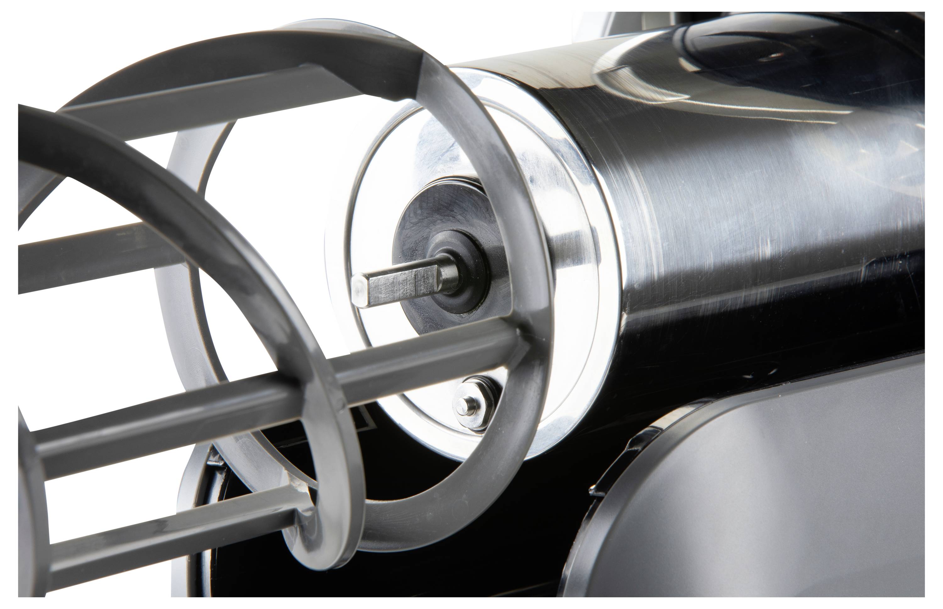 Close-up of a metallic machine rotor or engine component with curved blades and a central shaft.