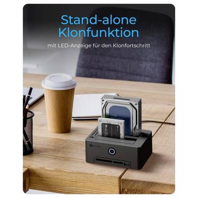 Product promo showing a standalone clone function dock with LED progress indicator, holding hard drives on a wooden desk beside a coffee cup and laptop.