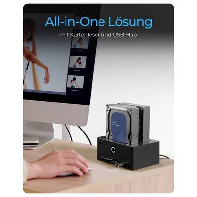 Desktop promotional image of a computer connected to an 'All-in-One Lösung' device with card reader and USB hub on a desk, beside a monitor.<br>