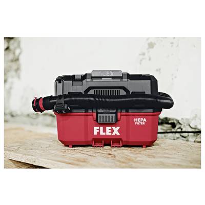 Red FLEX HEPA filter vacuum with black hose attached, sitting on a wooden surface against a light background.