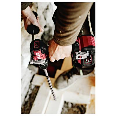 Person using a red cordless power drill to bore into a white surface, viewed from above.