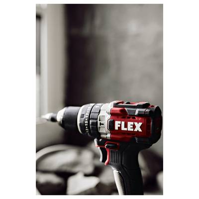 Close-up of a red-and-black FLEX cordless drill/driver on a work surface, shown in profile with the bit pointing left.
