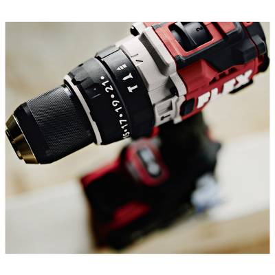 Close-up of a red-and-black cordless drill with chuck and torque settings visible, resting on a blurred workbench.