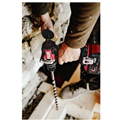 Person using a cordless power drill with a long auger bit to bore into a wall or floor, likely during construction or renovation.