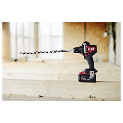 Cordless FLEX drill with a long auger bit resting on a wooden beam at a construction site.