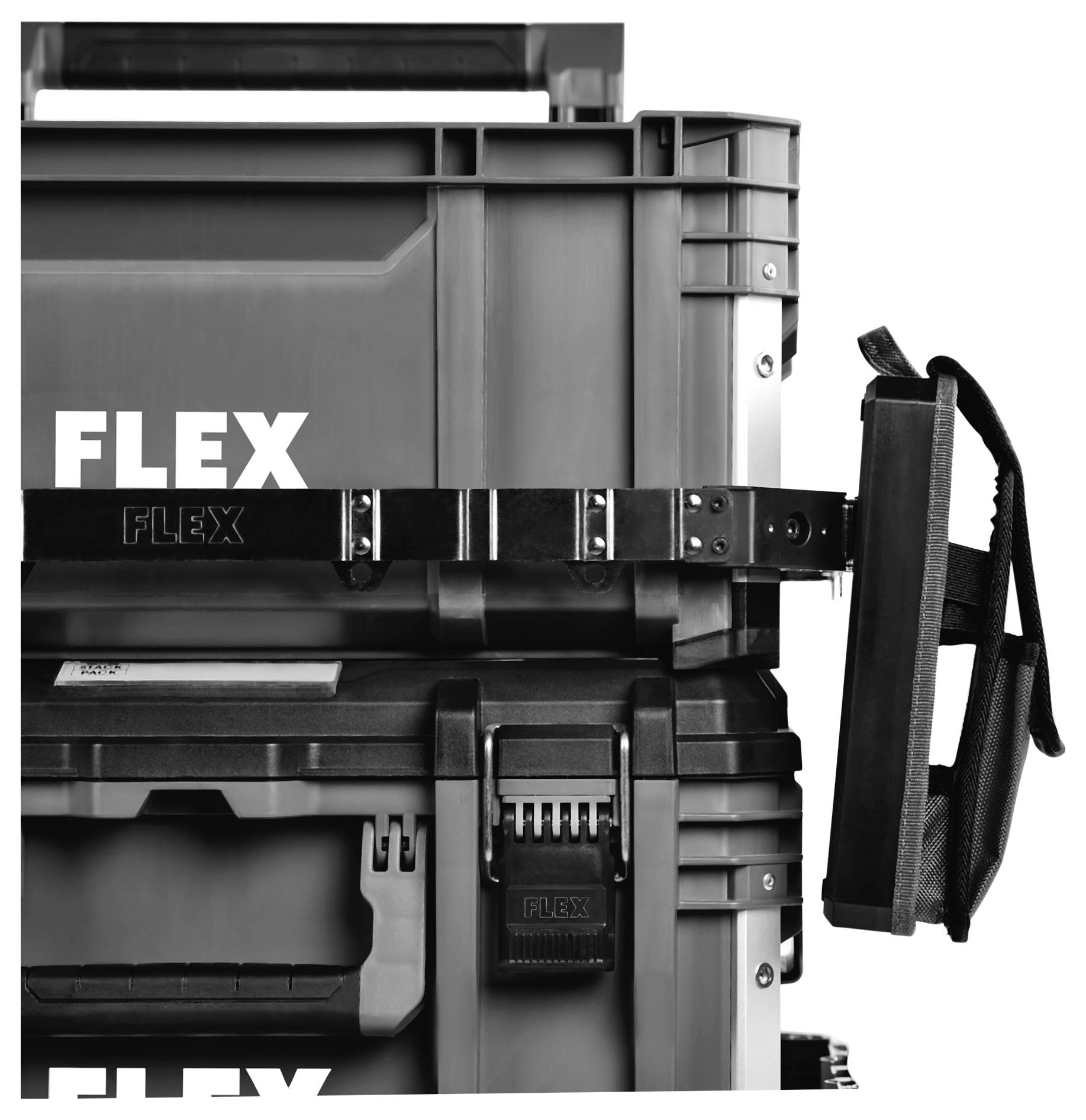 Close-up of a black FLEX hard case tool box secured with a strap and handle visible on the right.
