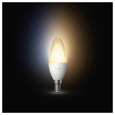 A glowing Philips Hue-style smart light bulb on a dark background, emitting warm white light with a soft halo.<br>
