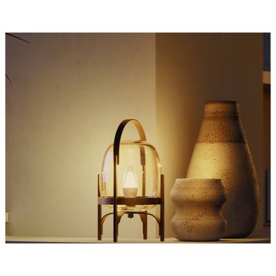 Warm-lit decorative table lamp on a shelf beside two ceramic vases, creating a cozy interior scene.