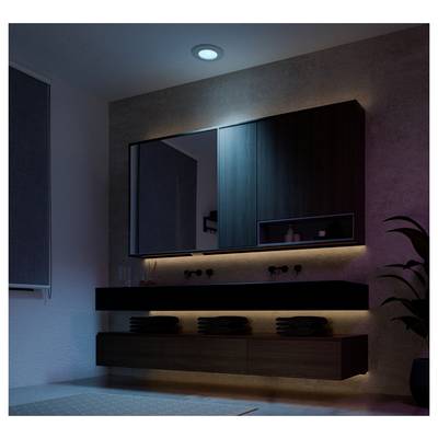 Dim modern bathroom with floating vanity, mirror cabinet, under-cabinet lighting, and minimal decor in blue-purple ambient light.
