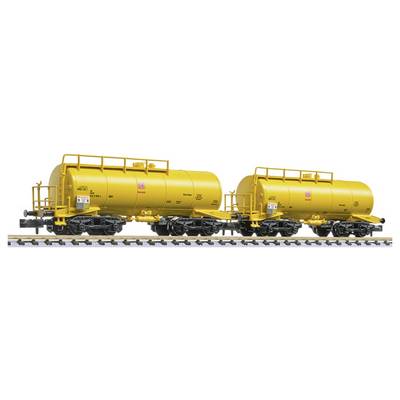 Two yellow tanker railcars on tracks, shown side by side with black undercarriages and ladders on top.
