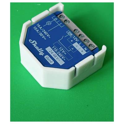 Blue Shelly smart home relay module in white case, showing wiring terminals and printed voltage ratings on a green background.