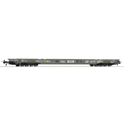 Side view of a gray flatbed railroad railcar with multiple wheel assemblies, yellow tie-down points, and a central logo panel.