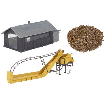Industrial facility with a conveyor system and large pile of raw material pellets, suggesting material handling or processing equipment.