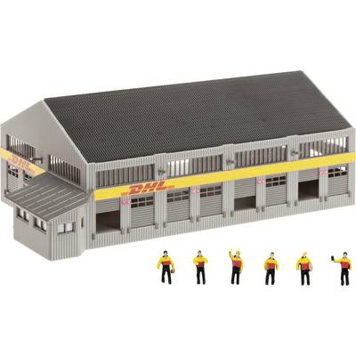 Model of a DHL warehouse loading dock with six worker figures in front, showing the building’s size and scale.