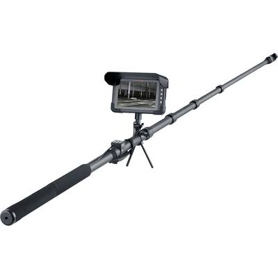 Long-range inspection camera on a telescoping pole with grip handle and tripod stand, showing a monitor previewing an indoor construction site.