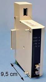 Compact beige metal device shown in side view with a labeled dimension of 9,5 cm, and visible front panel connectors or ports.<br>