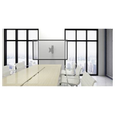 Modern empty conference room with long table, white chairs, wall-mounted screen, and floor-to-ceiling windows overlooking a city skyline.
