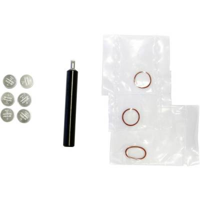 Assorted small parts laid out on white: six silver coin batteries, a black cylindrical tool, and three clear plastic bags with red rubber O-rings.