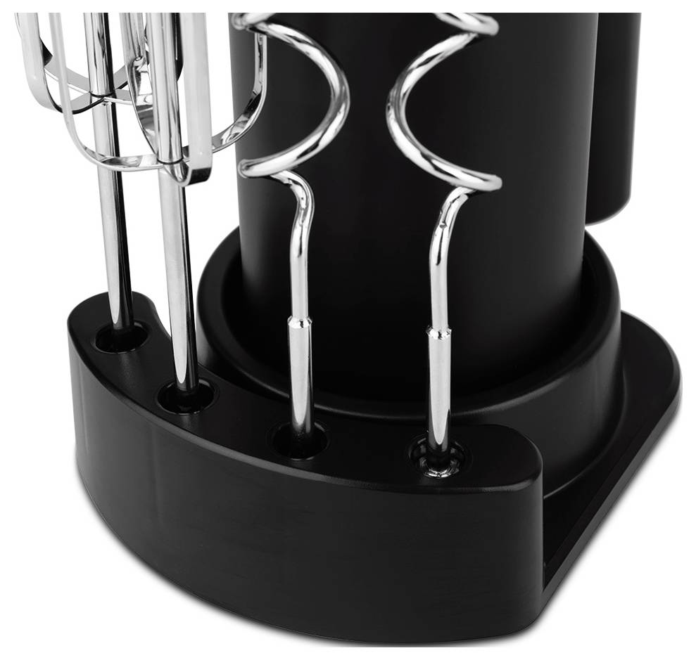Close-up of a black countertop utensil holder with several chrome kitchen tools inserted in slots.