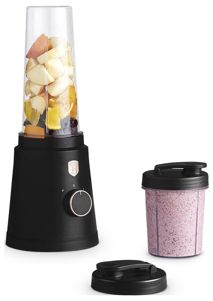 Black blender base with cup of mixed fruit on left, plus a pink smoothie cup and separate lid on the right.