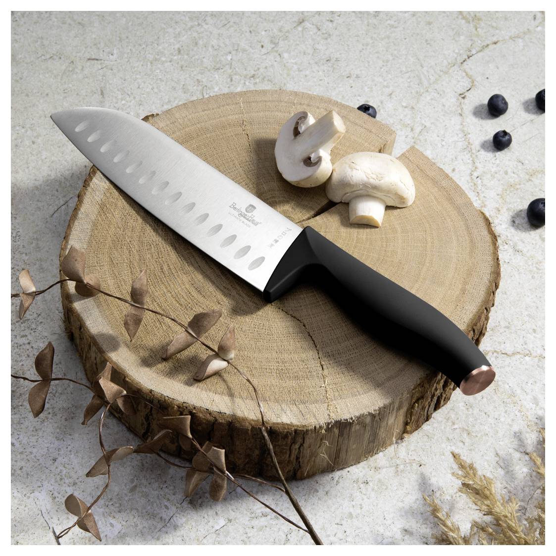 Kitchen knife resting on a tree stump with sliced mushrooms, shown in a rustic food-prep still life.