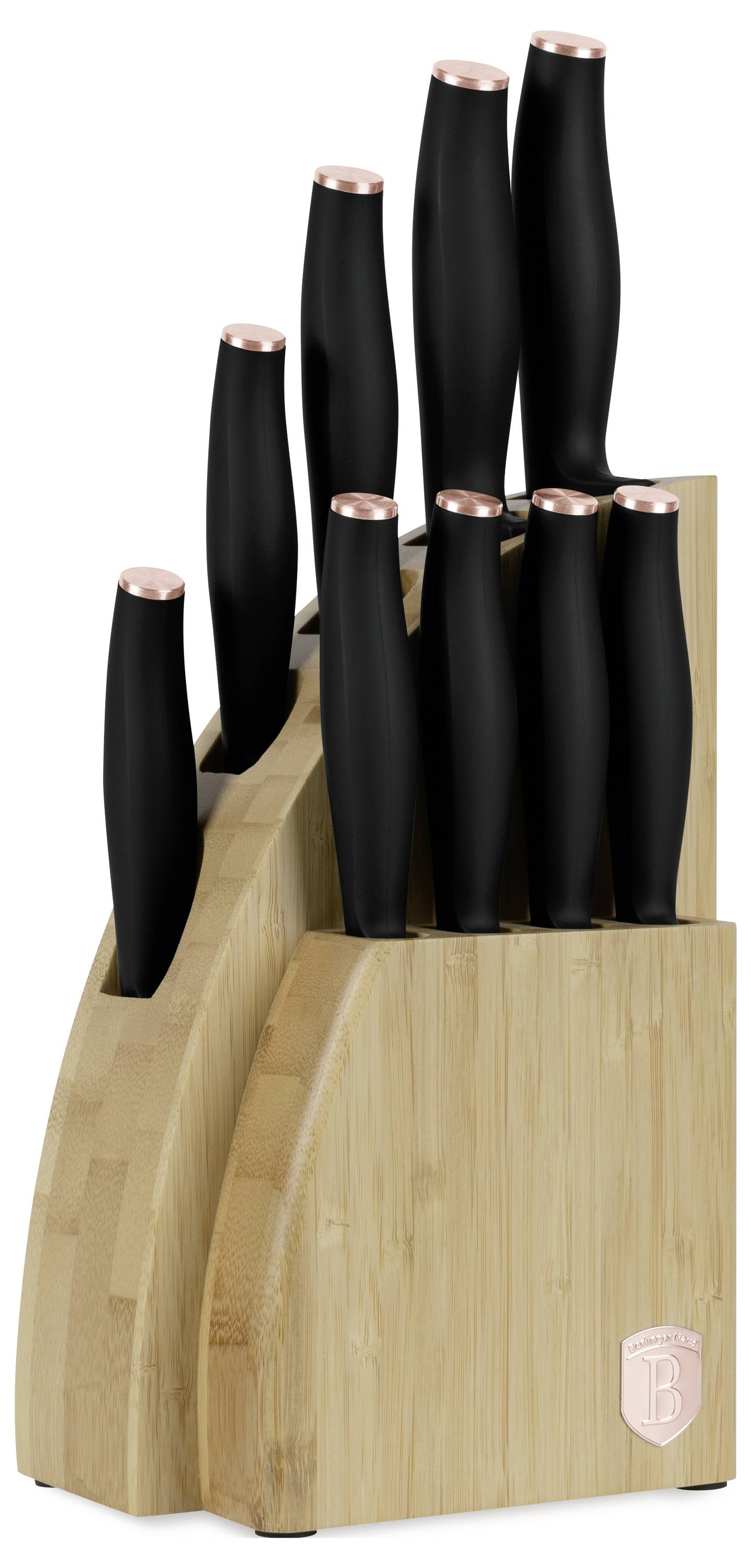 Wooden knife block holding several black-handled knives with copper-colored tops, viewed on a white background.